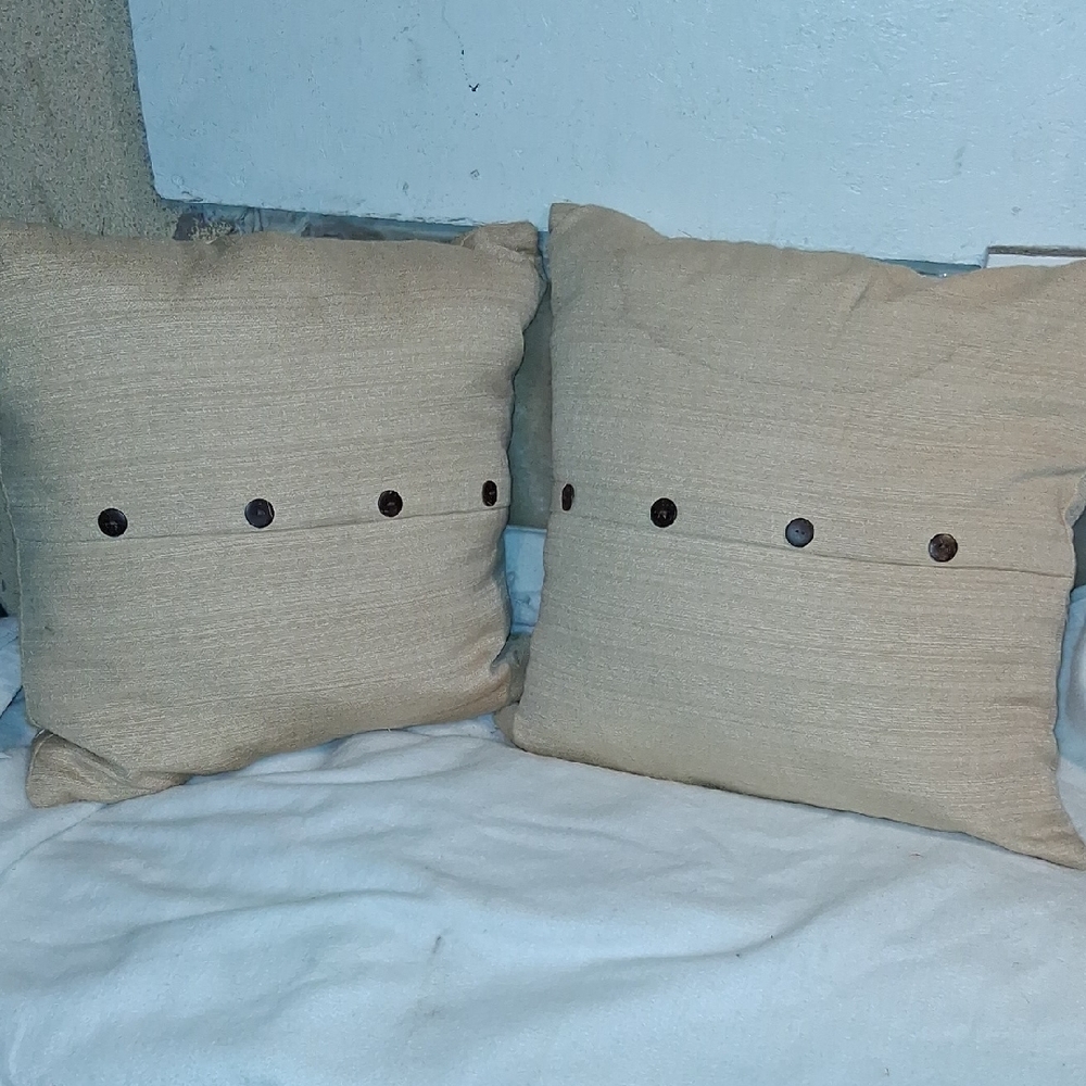 Two yellow Throw Pillows with BrownButton Details zipper side
